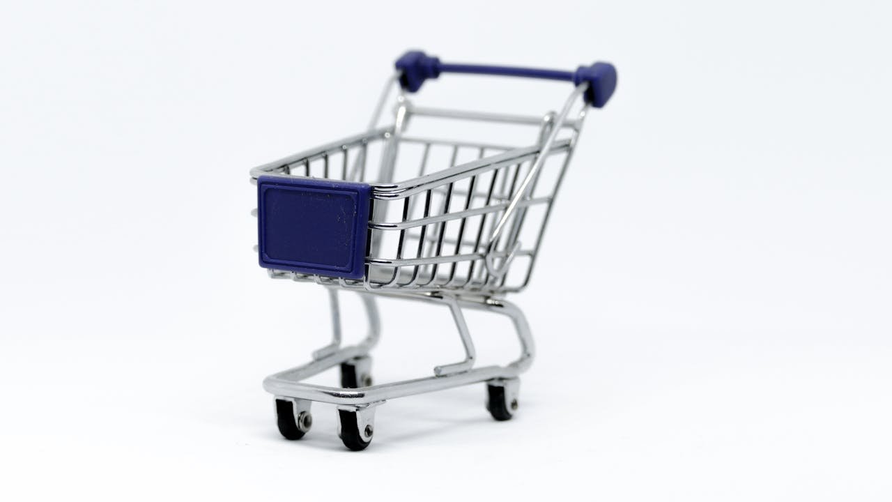 about-02 A modern miniature shopping cart on a clean white background, perfect for e-commerce concepts.